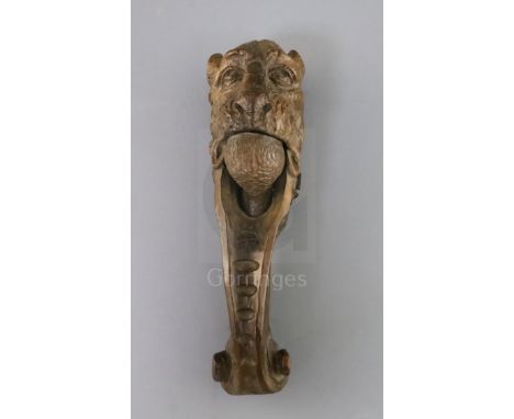 An early 19th century treen nutcracker, carved with the head of a lion, 10in.