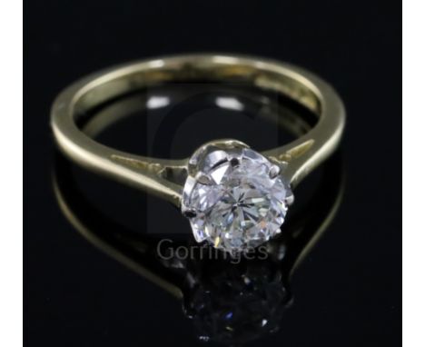 A modern 18ct gold and solitaire diamond ring, the round brilliant cut stone weighing 1.04cts, size K.