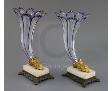 A pair of Bohemian blue flashed glass cornucopia vases, 19th century, each trumpet shaped vessel, issuing from ormolu ram's h