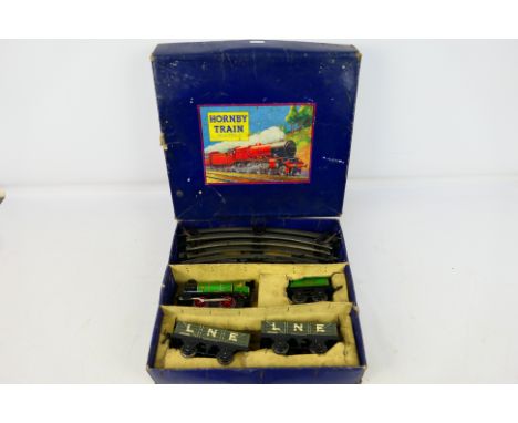 Hornby - A boxed O gauge clockwork M1 Goods Set with green locomotive and tender and 2 x wagons. The set shows some signs of 