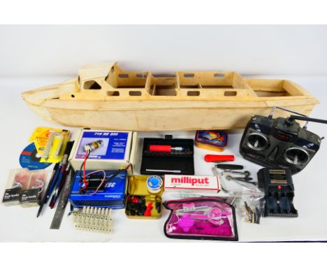 Wooden model kit - A part-assembled wooden powered boat model kit; unknown maker (90cm long) and a controller. Item appear to