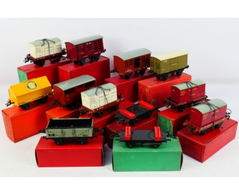Hornby - A collection of 12 x O gauge wagons including 4 x low sided wagons, a lumber wagon, cattle truck, cement wagon, meat