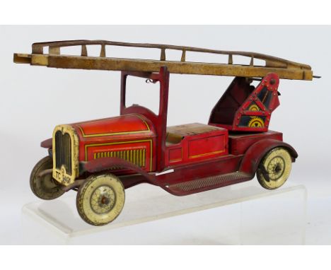 Tipp & Co - A vintage unboxed tinplate clockwork fire engine. Item appear to be in a fair condition with its bell accessory b