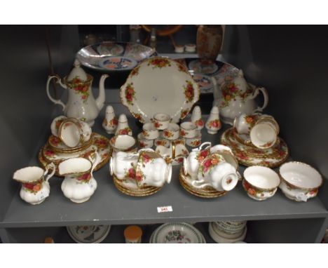 A Royal Albert bone china tea service, decorated in the old country rose pattern, to include small lobed form cups and saucer