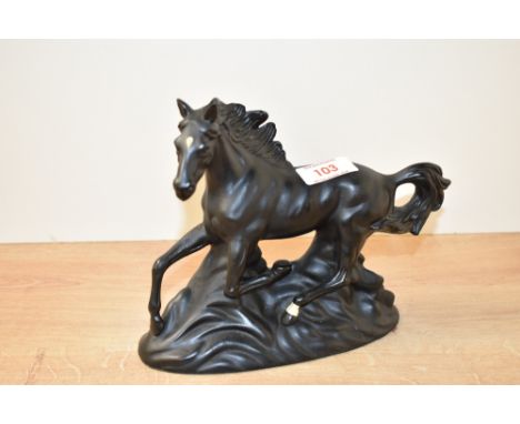 A vintage porcelain study of a black stallion running, h16cm.