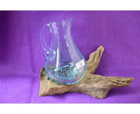 A contemporary Indonesian planter, hand crafted from root wood with one moulded transparent glass jug, L29 x H21cm.