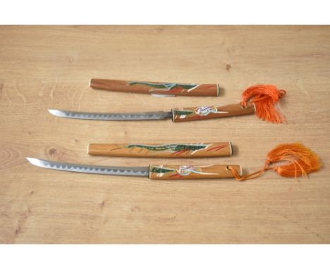 A pair of vintage Japanese miniature samurai Katana letter openers, hand painted with dragon's and orange tassels, 20cm.