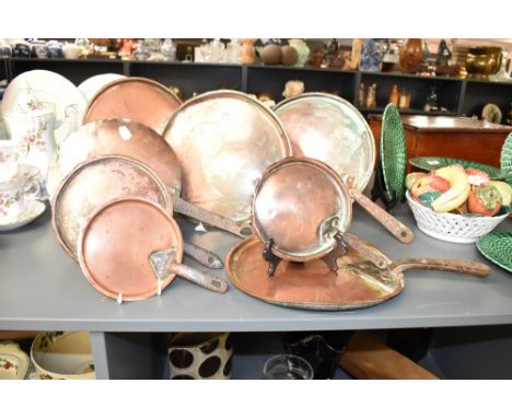 A set of late 19th / early 20th century copper pan lids with iron handles, various sizes, one lid impressed with mark 'R 21',