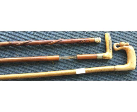 A small sword stick together with a walking cane etc. Est. £30 - £50.