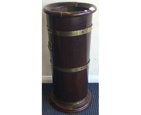 A mahogany and brass mounted stick stand. Est. £30 - £40.