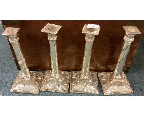 A good set of four silver plated candlesticks. Est. £20 - £30.