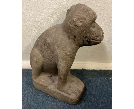 An Antique large stone model of a monkey with textured body in seated position. Est. £100 - £150.