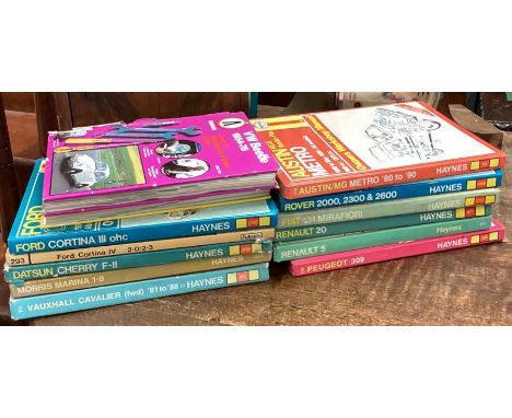 A collection of Haynes manuals together with a clock, wall cupboard etc. Est. £10 - £20.