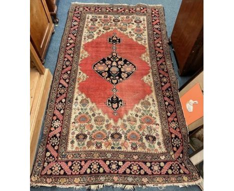 A good red tapestry rug with floral border and central medallion. Approx. 115 cms x 202 cms. Est. £60 - £80.