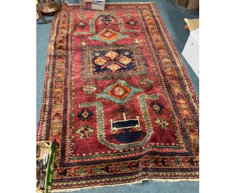 A good red ground tapestry rug with central medallion. Approx. 260 cms x 152 cms. Est. £60 - £80.