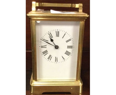 A brass carriage clock with white enamelled dial. Est. £50 - £80.