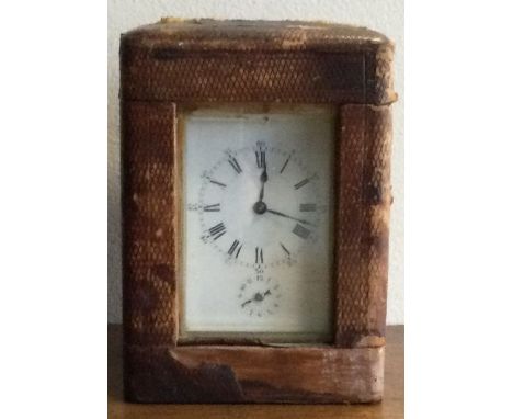 A heavy French brass carriage clock in leather travelling case. Est. £100 - £150.