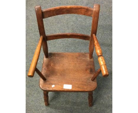 An old child's stick back chair. Est. £20 - £30.