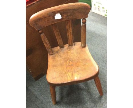 A small child's stick back chair. Est. £15 - £20.