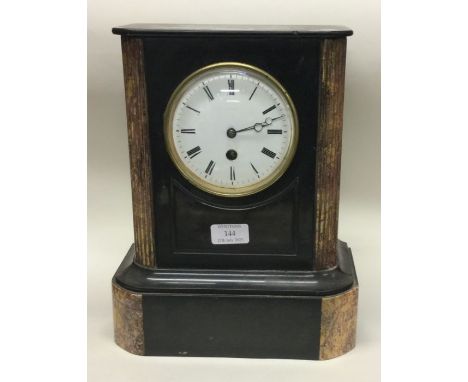 A large slate mantle clock with white enamelled dial. Est. £15 - £20.