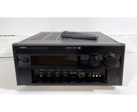 A Yamaha DSP-AX1 natural sound AV amplifier with remote. Powers on.