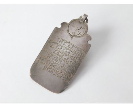 BOOK OF SOLOMON. A silver coloured metal pendant, engraved to both sides with Hebrew script from the Book of Solomon. Further