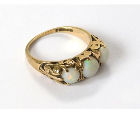 OPAL RING. A 9ct. gold dress ring set with three large cabouchon opals. Size O/P.  Please note that all items in this auction