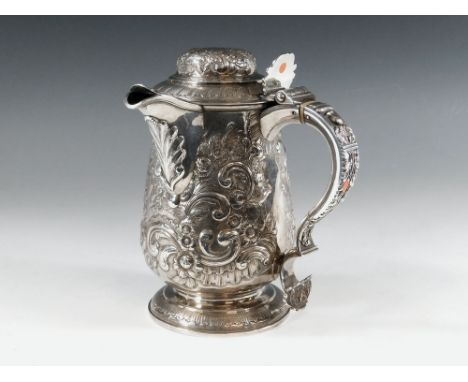 GEORGIAN SILVER. A George IV presentation, silver spouted tankard, the body with floral & foliate decoration & a cartouche wi