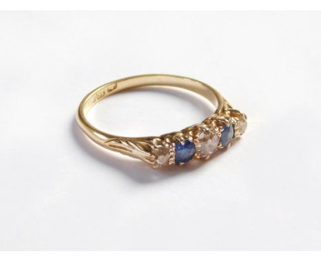 GOLD RING. An 18ct. gold ring, set with three old cut diamonds & two sapphires. Approx. 3.3g. Size R/S.  Please note that all