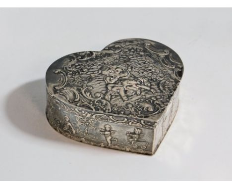 SILVER BOX. An early 20th century German silver heart shaped box, embossed with cherubs, shells & swags. Import mark for Lond