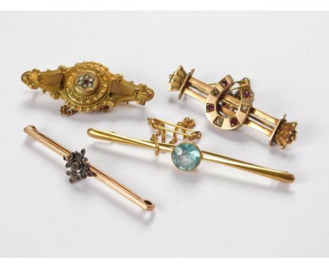 BAR BROOCHES. An Edwardian 9ct. gold bar brooch set a ruby & half pearls. Also, a 9ct. gold & blue topaz bar brooch, one othe