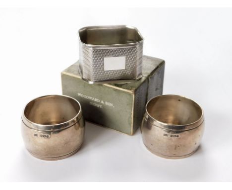 NAPKIN RINGS. A pair of Mappin & Webb plain silver napkin rings & a modern engine turned napkin ring in a fitted box.  Please