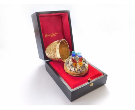 STUART DEVLIN.  A Stuart Devlin textured silver gilt Surprise egg, opening to reveal two enamelled butterflies, one 'en tremb
