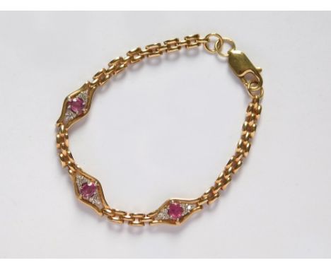 GOLD BRACELET. A modern 9ct. gold bracelet set with three groups of ruby & diamond clusters. Approx. 11.9g.  Please note that