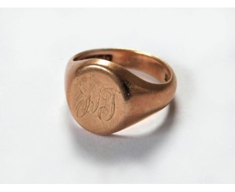 SIGNET RING. A gentleman's 9ct. rose gold signet ring with faint monogram. Approx. 9.9g. Size R/S.  Please note that all item