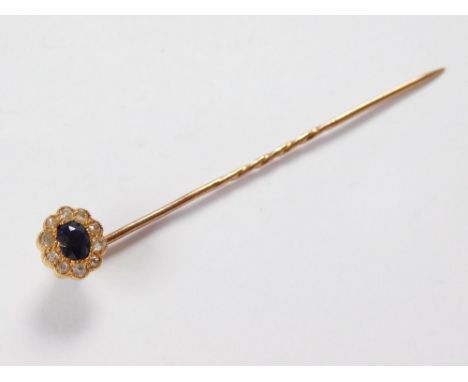 STICK PIN. A diamond & sapphire cluster stick pin set in yellow metal.  Please note that all items in this auction are previo