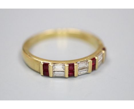 A modern 18ct gold, square cut ruby and baguette cut diamond set half hoop ring, size Q, gross 3.6 grams.