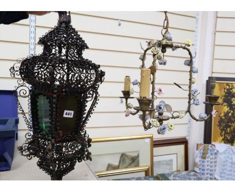 An Italian wrought iron and coloured glass hanging lantern and a brass chandelier, mounted with porcelain, lantern approximat