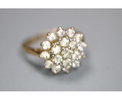 A modern 9ct gold and cubic zirconia cluster set dress ring, size J, gross 2.3 grams.