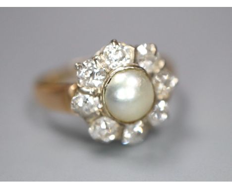 A yellow metal, cultured pearl and diamond set flower head cluster ring, size L, gross 3.1 grams, pearl a probable replacemen