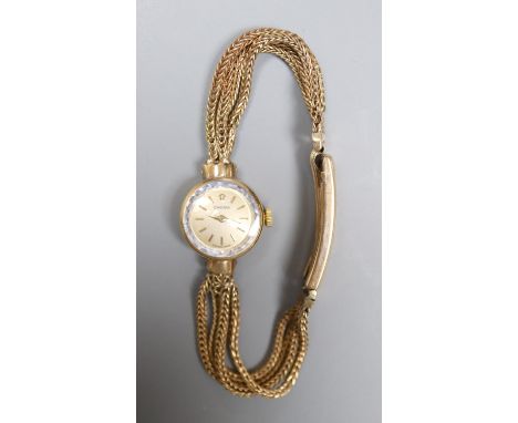 A lady's 1960's 9ct gold Omega manual wind wrist watch, on multi strand bracelet with expanding clasp, gross 20.9 grams.