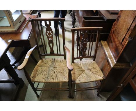 A set of six early 20th century beech ladder back dining chairs (two with arms)