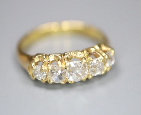 An 18ct and graduated five stone old cut diamond set child's ring, size E/F, gross 2.5 grams.