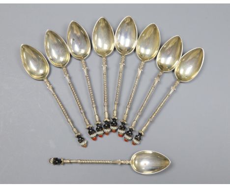 A set of nine early to mid 20th century Austro Hungarian white metal and enamel coffee spoons, with Blackamoor head terminals