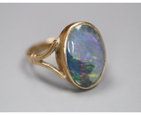 A 9ct and opal doublet set oval ring, size J, gross 2.7 grams.