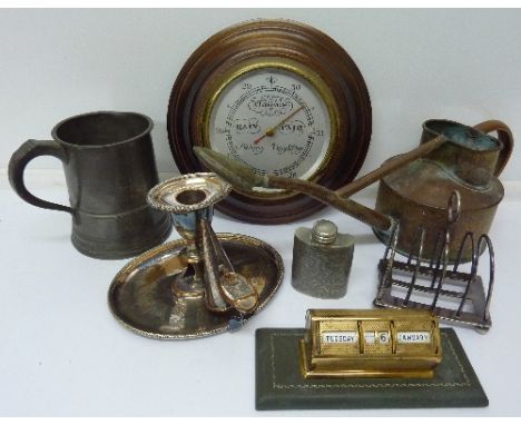 Metalwares including a pewter flask, a copper watering can, a chamberstick, an aneroid barometer and desk calendar