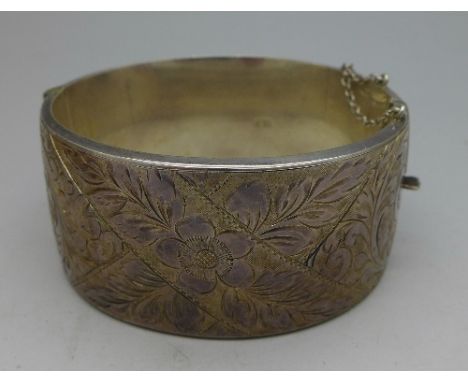 A large silver bangle, boxed, weight 52.1g, width 31mm