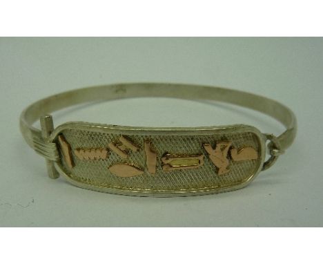 An Egyptian silver and 22ct gold bangle