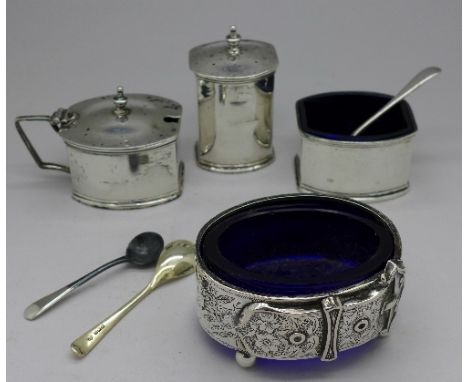 A three piece silver condiment set and a salt made from a Victorian silver bangle with buckle decoration