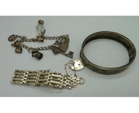 A Victorian silver bangle, a gate bracelet and a silver charm bracelet, weight 49.5g